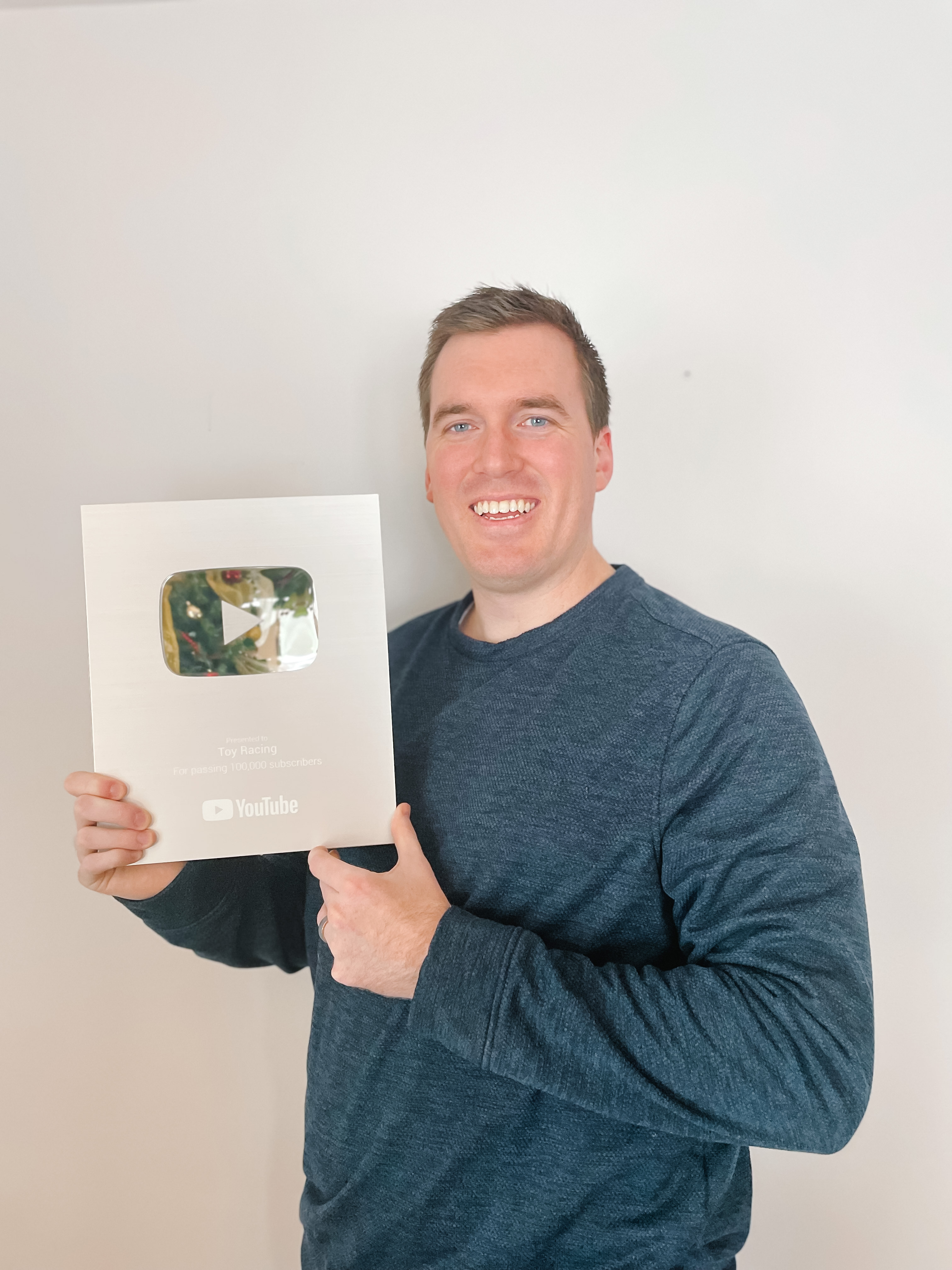 Rob, founder of Creator Essentials, holding his YouTube Silver Play Button
